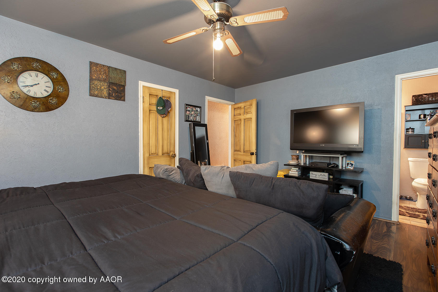 6017 Calumet Road Amarillo, TX 79106 - Photo 22 of 31 a bedroom with a bed and a flat screen tv
