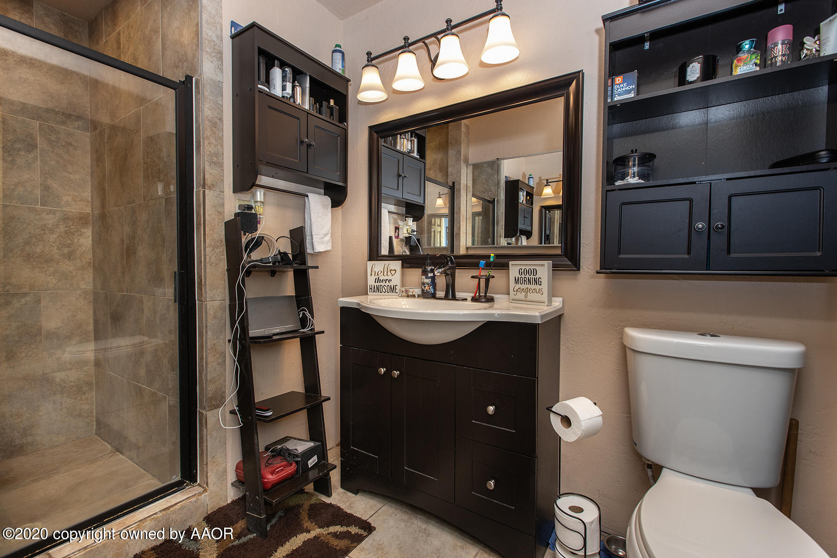 6017 Calumet Road Amarillo, TX 79106 - Photo 23 of 31 a bathroom with a toilet sink and mirror