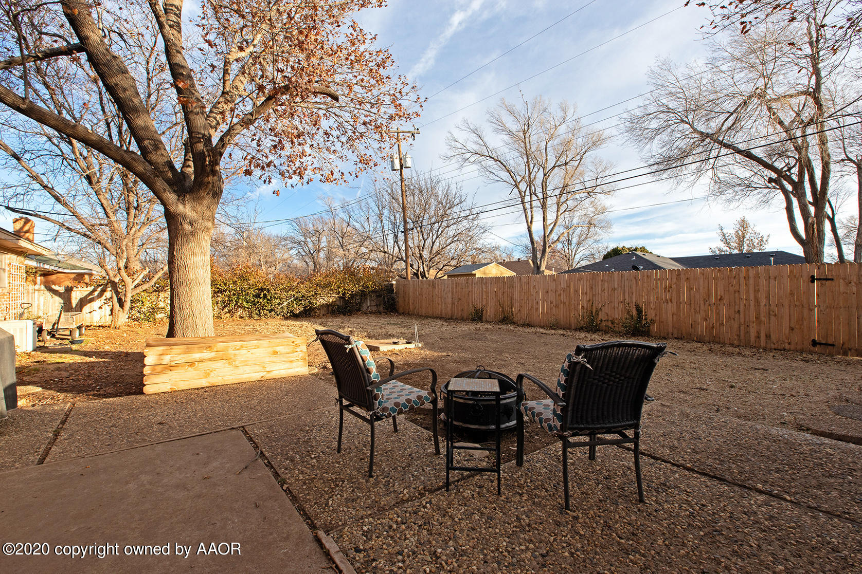 6017 Calumet Road Amarillo, TX 79106 - Photo 30 of 31 a view of a patio with table and chairs with wooden fence and large trees