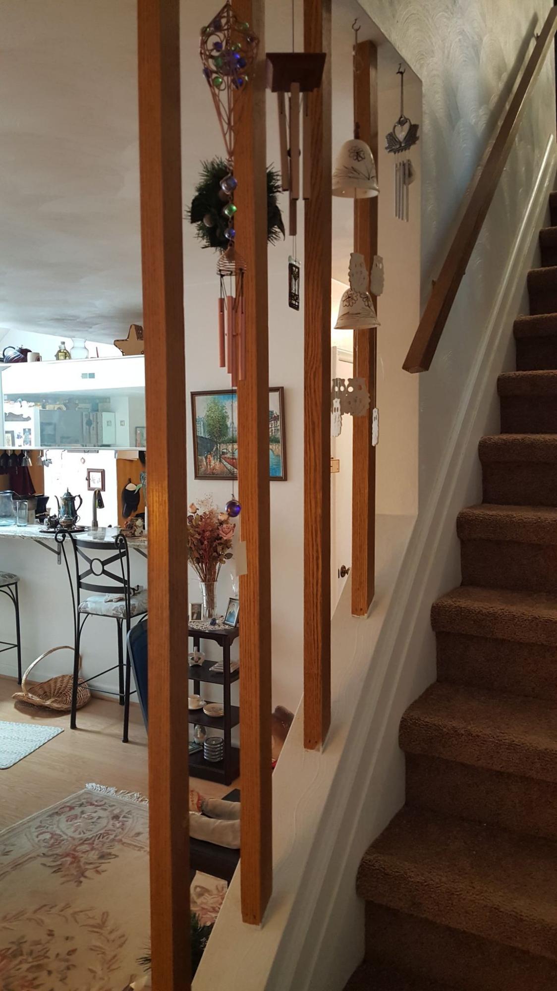 3337 Forest Ridge Road Roanoke, VA 24018 - Photo 8 of 36 a view of staircase with lots of frames on wall and a potted plant
