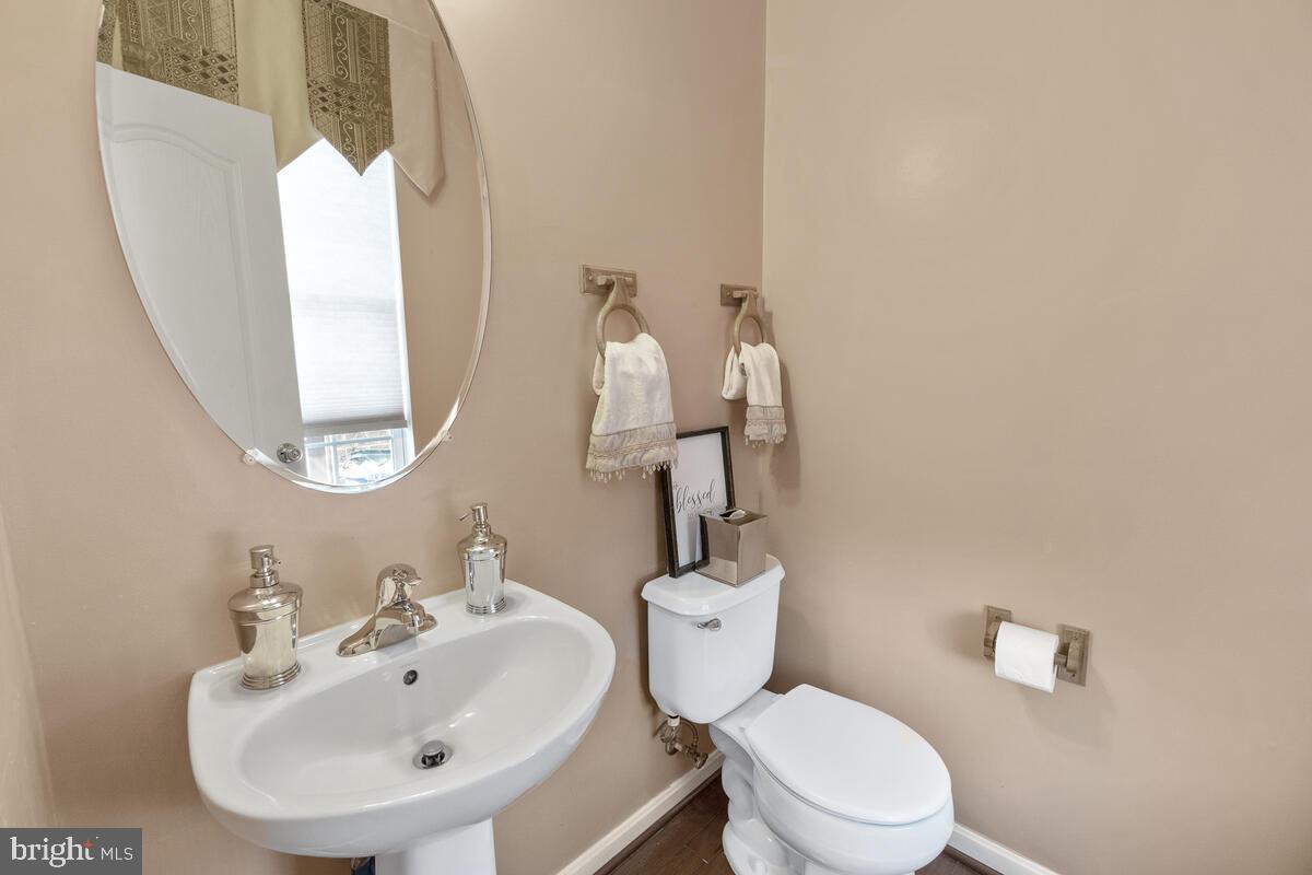112 Featherstone Place Frederick, MD 21702 - Photo 9 of 27 Main level powder room with hardwoods.
