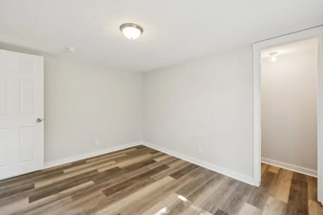 a view of a room with wooden floor