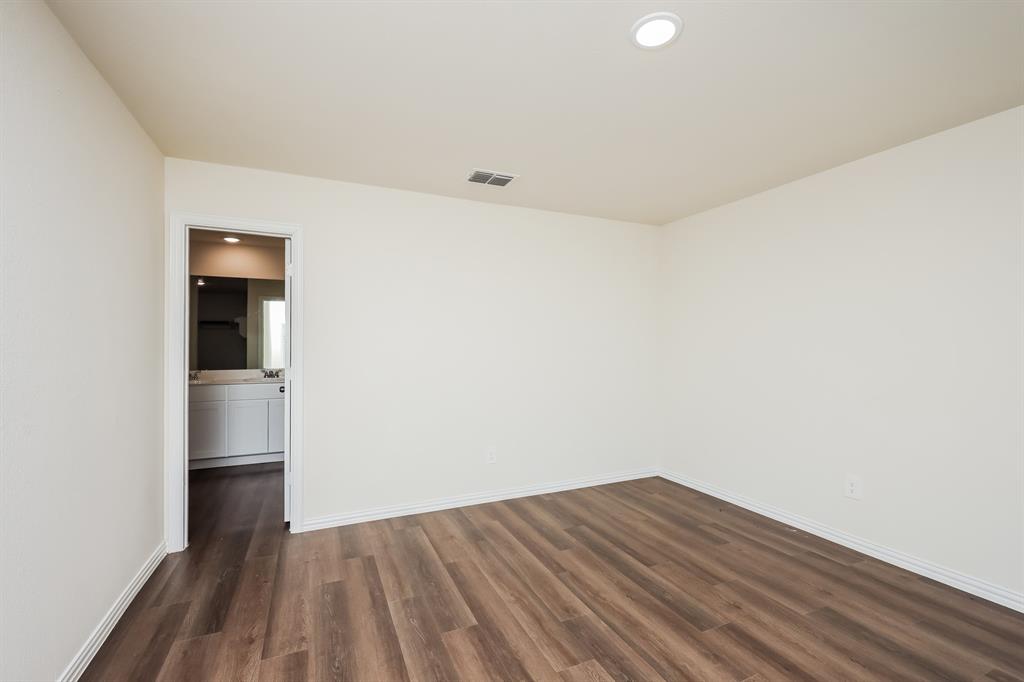 433 Shorty Street Mabank, TX 75147 - Photo 11 of 21 Spare room with baseboards, dark wood-style floors, visible vents, and recessed lighting