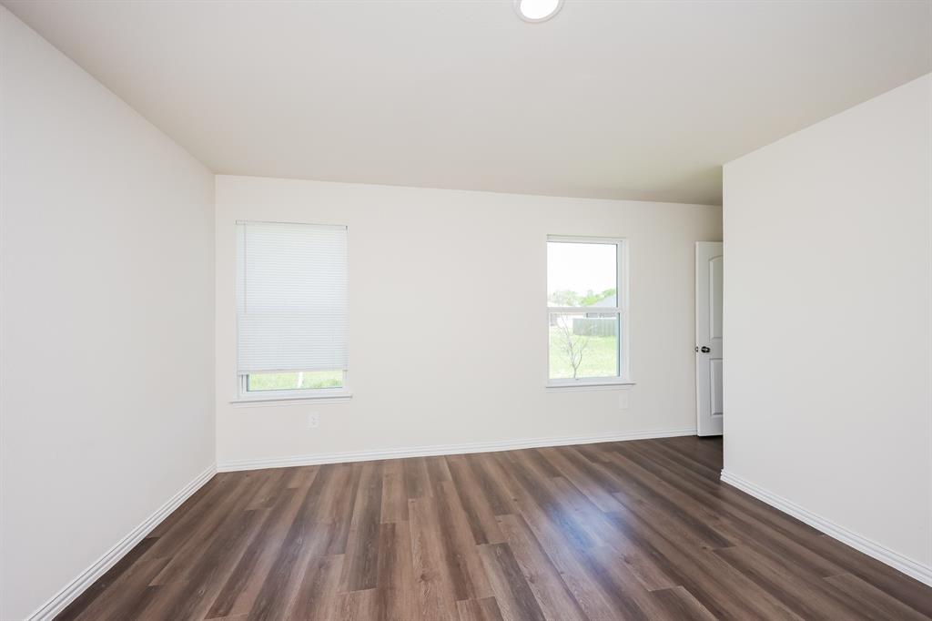433 Shorty Street Mabank, TX 75147 - Photo 12 of 21 Empty room featuring dark wood-type flooring and baseboards