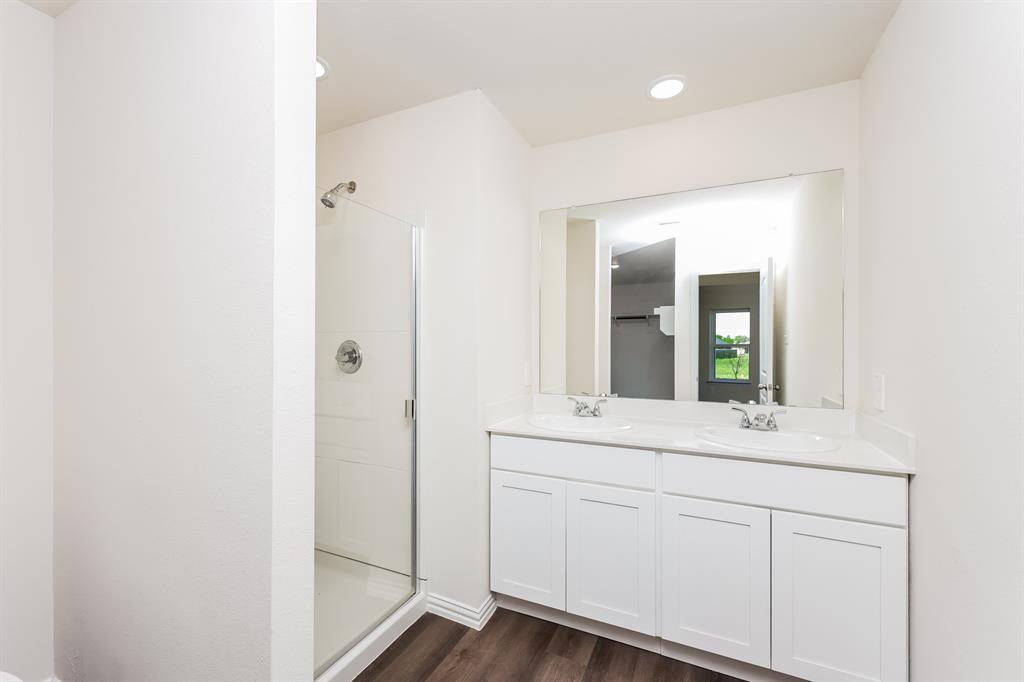 433 Shorty Street Mabank, TX 75147 - Photo 13 of 21 Full bathroom featuring a sink, a stall shower, and wood finished floors