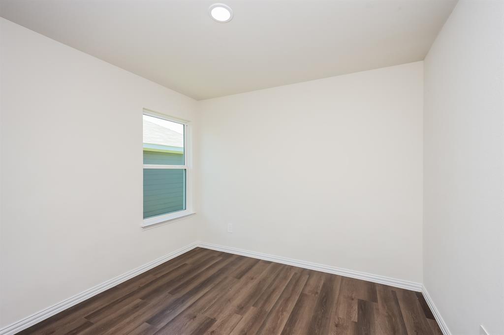 433 Shorty Street Mabank, TX 75147 - Photo 15 of 21 Empty room with dark wood-style flooring and baseboards