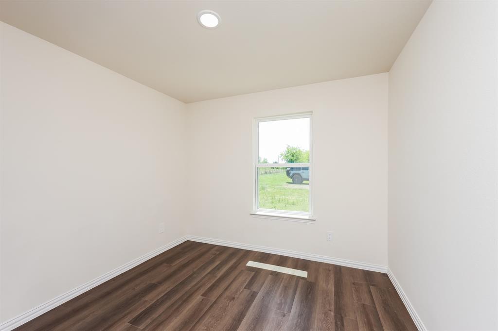 433 Shorty Street Mabank, TX 75147 - Photo 16 of 21 Empty room featuring baseboards and dark wood finished floors