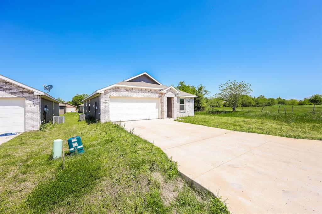 433 Shorty Street Mabank, TX 75147 - Photo 2 of 21 Ranch-style house featuring driveway, a front yard, a garage, and brick siding