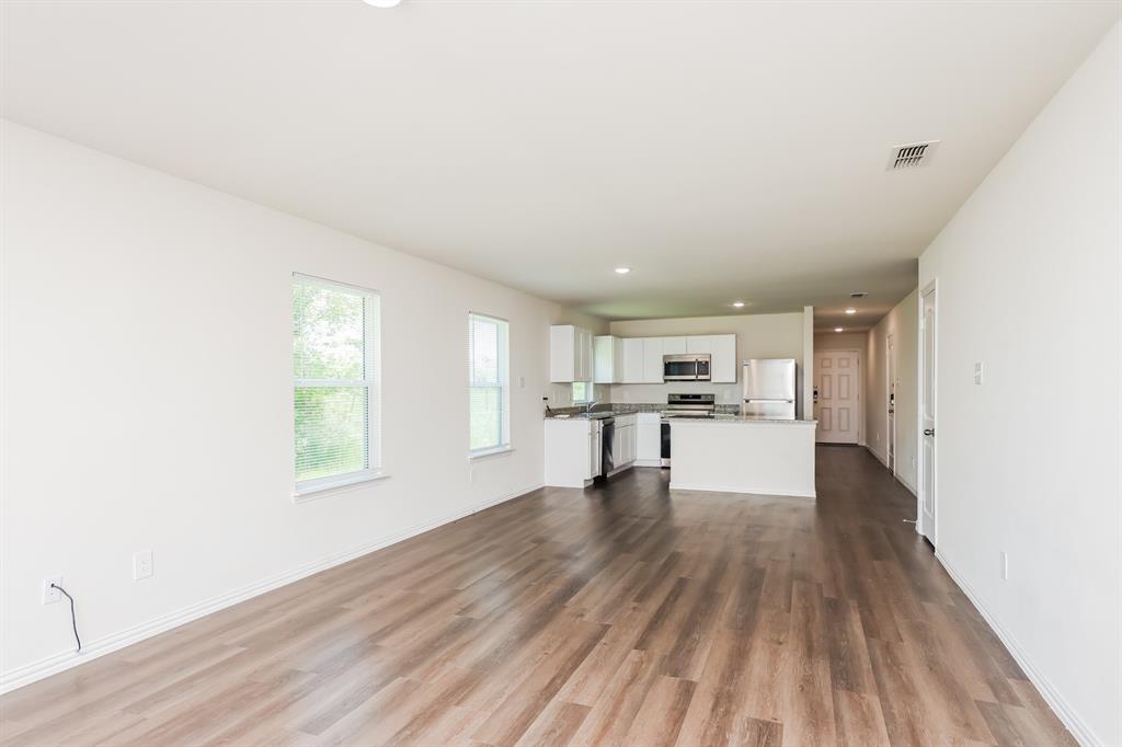 433 Shorty Street Mabank, TX 75147 - Photo 6 of 21 Unfurnished living room featuring recessed lighting, visible vents, baseboards, and dark wood finished floors