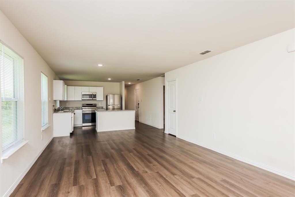 433 Shorty Street Mabank, TX 75147 - Photo 7 of 21 Unfurnished living room with dark wood-style flooring, visible vents, baseboards, and recessed lighting