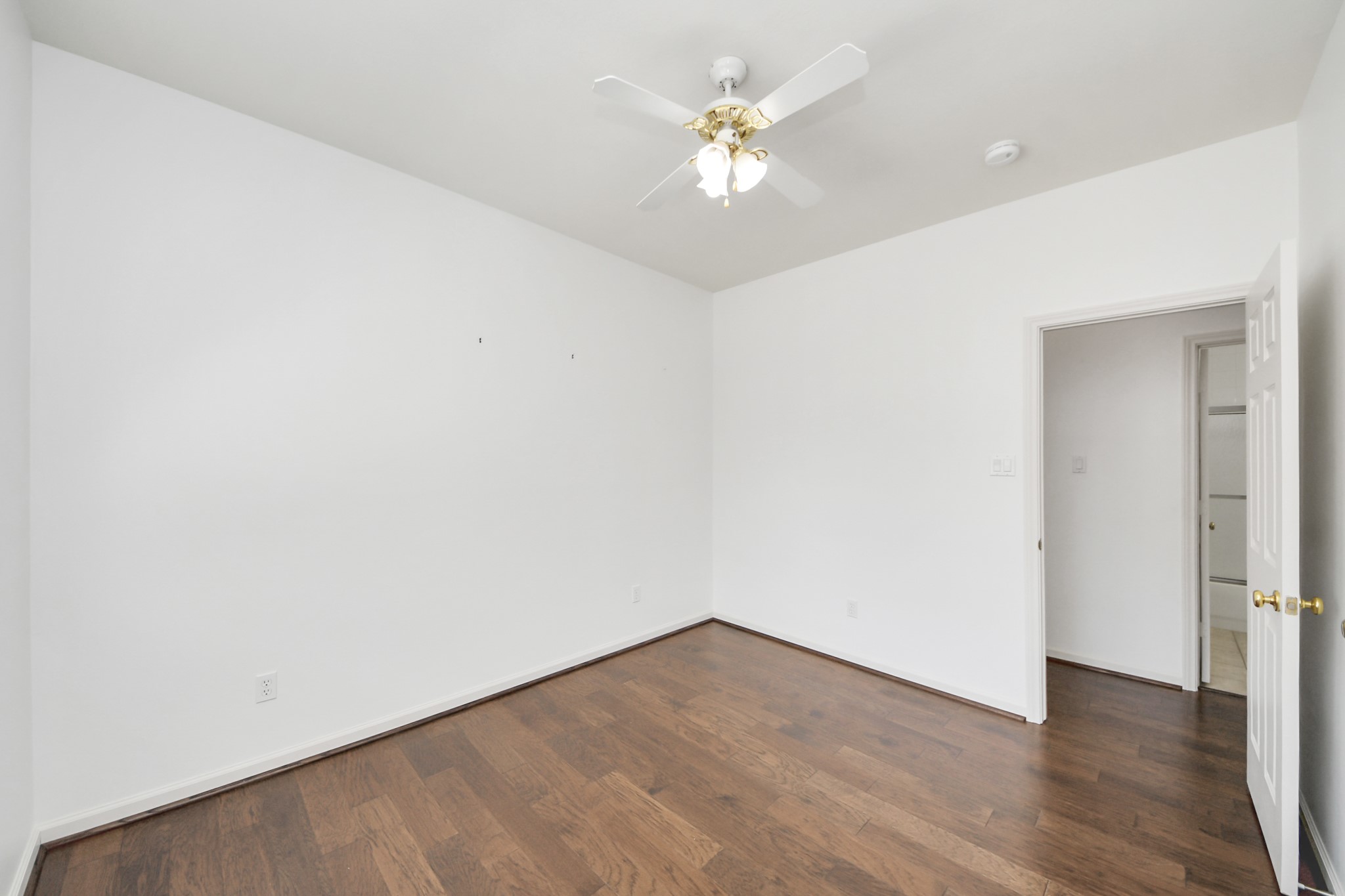 5815 Pheasant Ridge Lane Houston, TX 77041 - Photo 37 of 46 Bright and airy room with rich hardwood floors and a ceiling fan, offering a blank canvas ready for your personal touch.