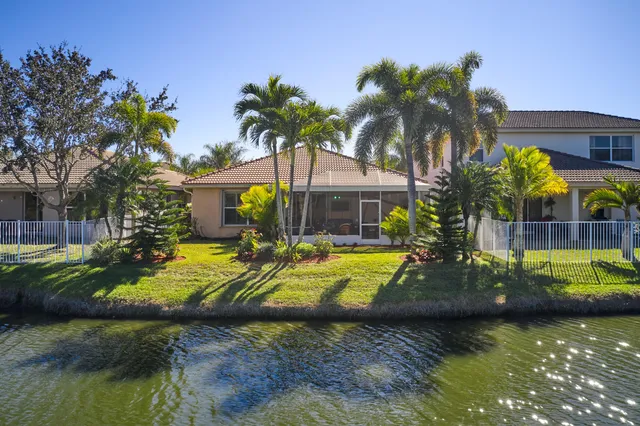 a view of a house with swimming pool and a yard
