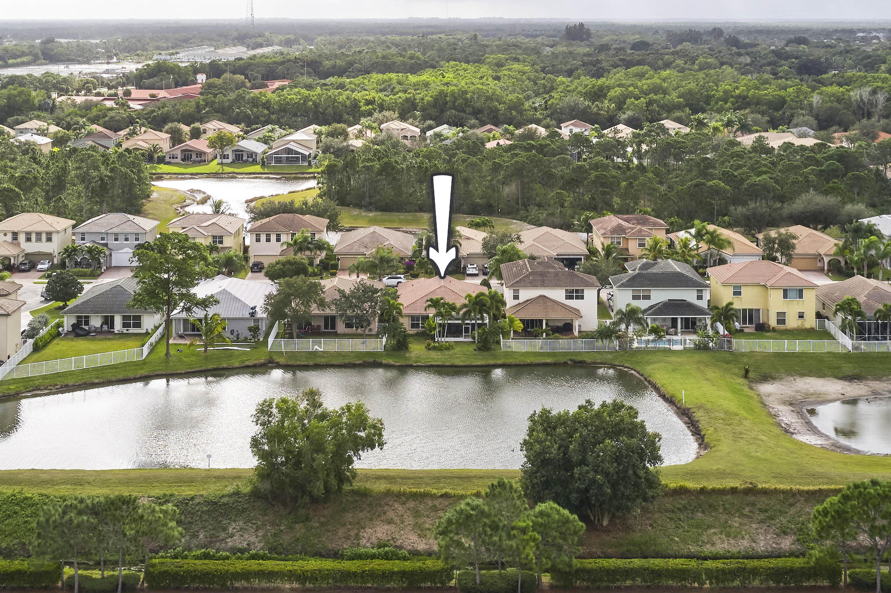an aerial view of residential houses with outdoor space and lake view