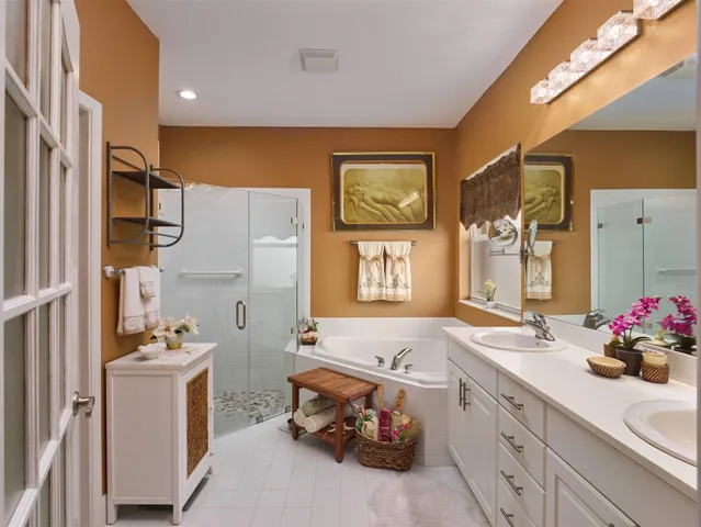 a bathroom with a sink mirror and tub