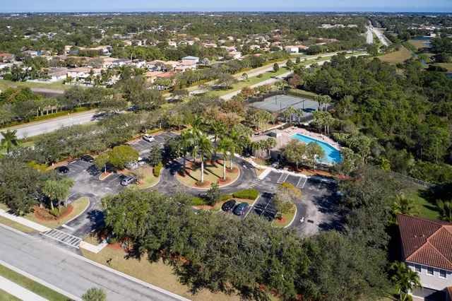 an aerial view of residential house with outdoor space and parking