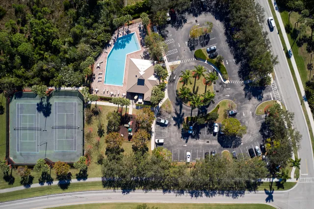 a view of a swimming pool with lawn chairs and couches