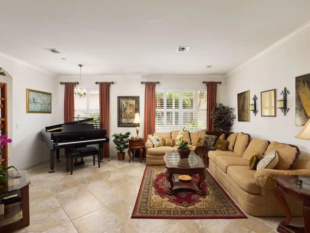 a living room with furniture a rug and a large window