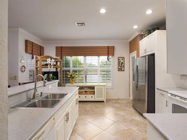 a kitchen with stainless steel appliances a sink a stove and a refrigerator