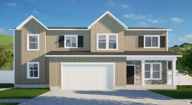 View of front of house featuring an attached garage, concrete driveway, and stone siding