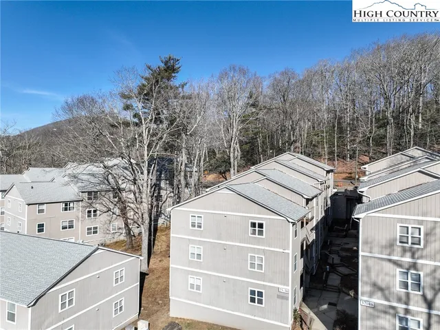 a view of a white house next to a road
