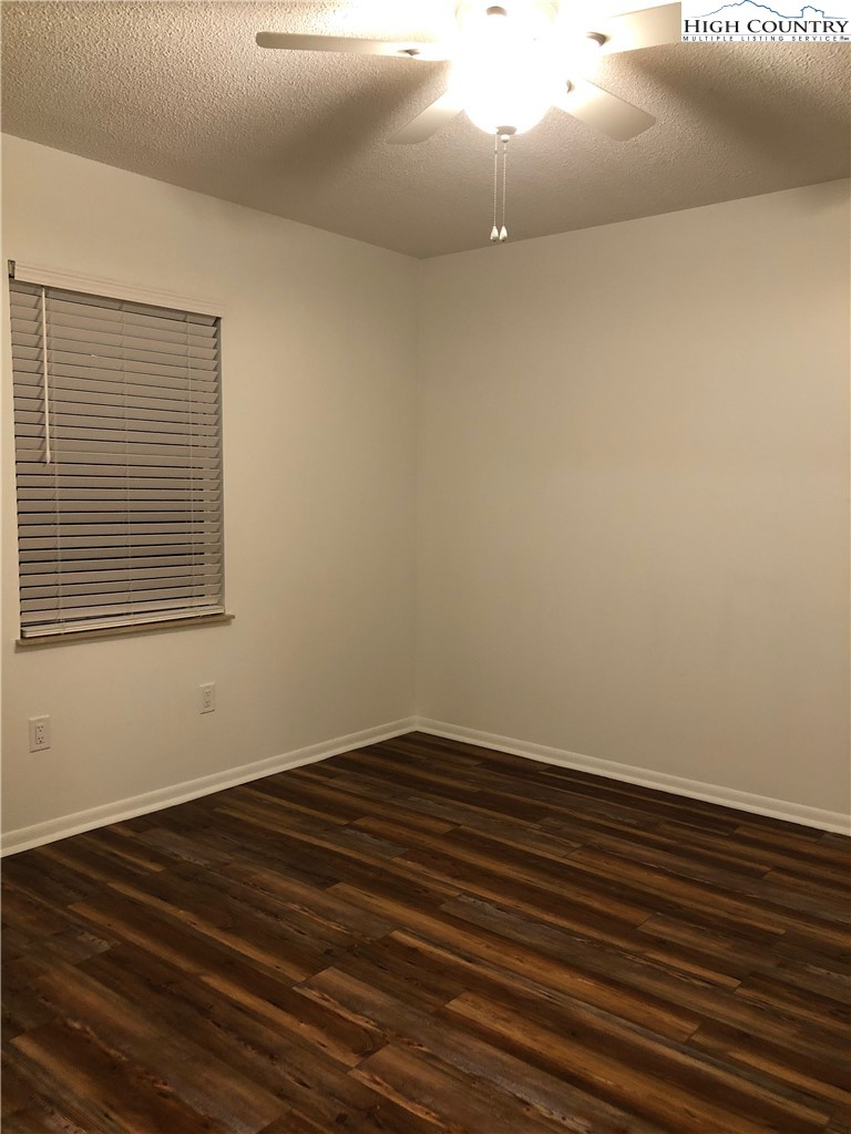 229 East King Street, Unit 9(1I) Boone, NC 28607 - Photo 6 of 19 a view of an empty room with wooden floor and a window