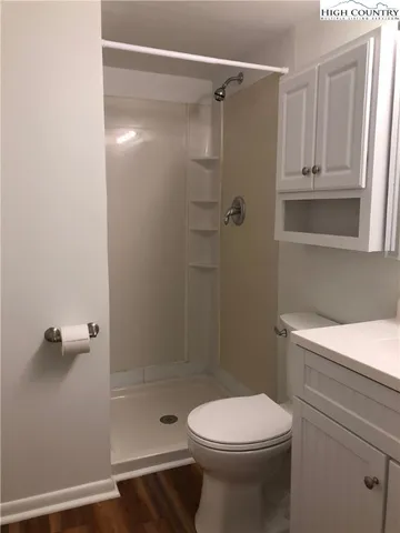 a bathroom with a shower a toilet and a sink