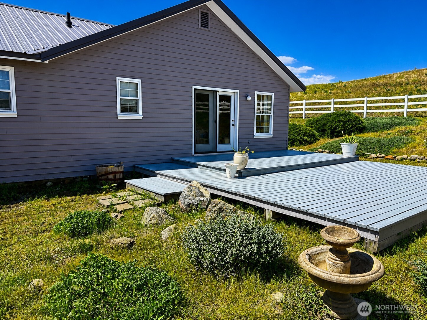 492 Pine Creek Road Tonasket, WA 98855 - Photo 21 of 37 a view of house with backyard outdoor seating and swimming tub