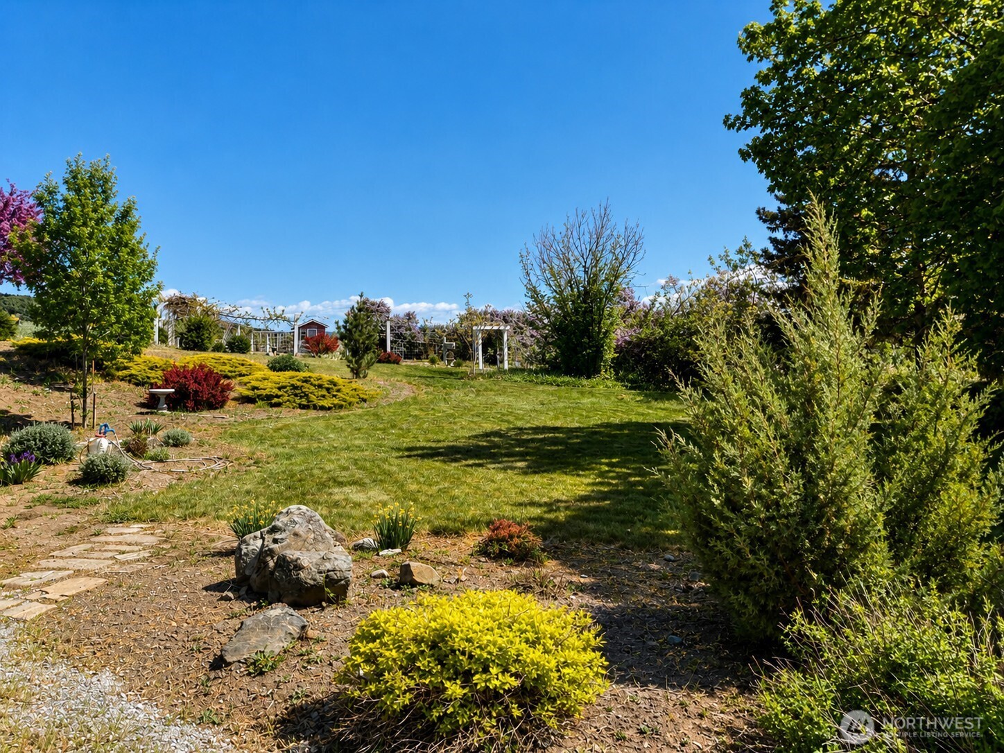 492 Pine Creek Road Tonasket, WA 98855 - Photo 31 of 37 a view of a garden with an outdoor space