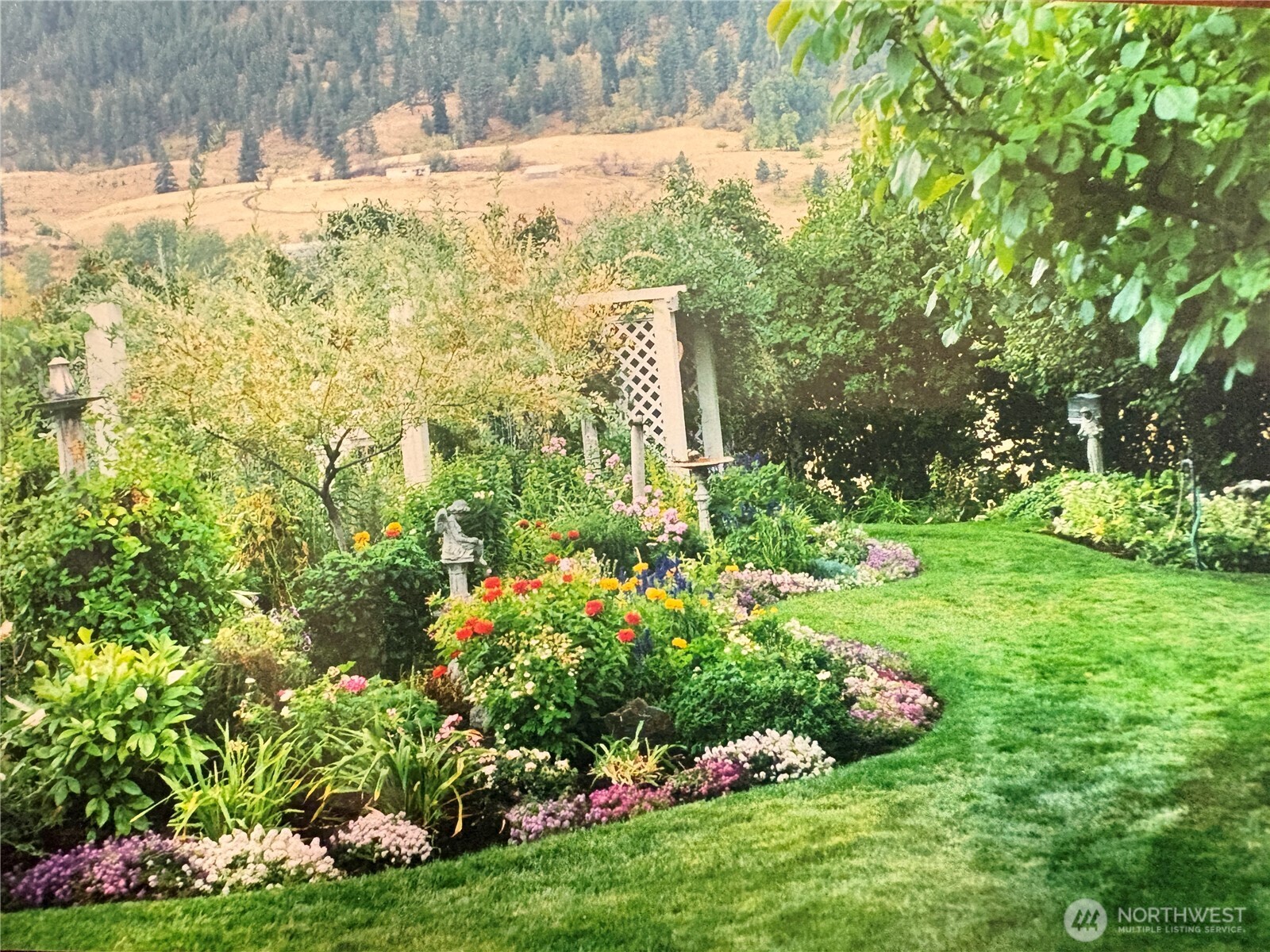 492 Pine Creek Road Tonasket, WA 98855 - Photo 37 of 37 a view of a garden with flowers