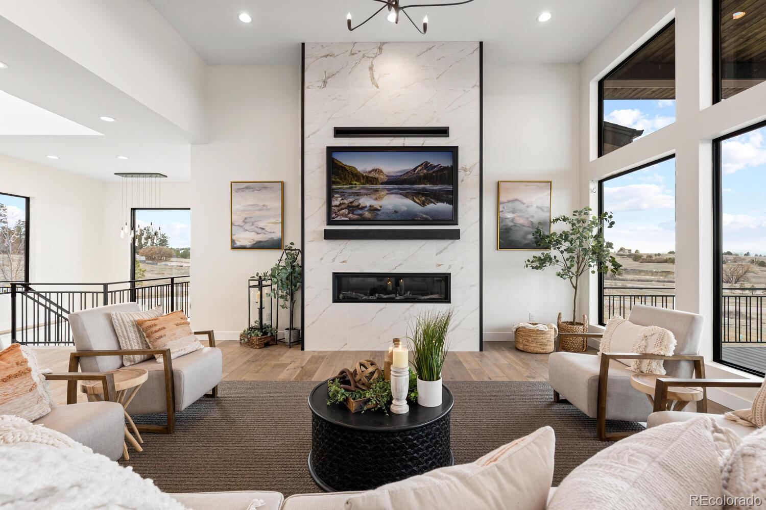 11115 Evening Hunt Road Franktown, CO 80116 - Photo 11 of 46 a living room with furniture and a fireplace