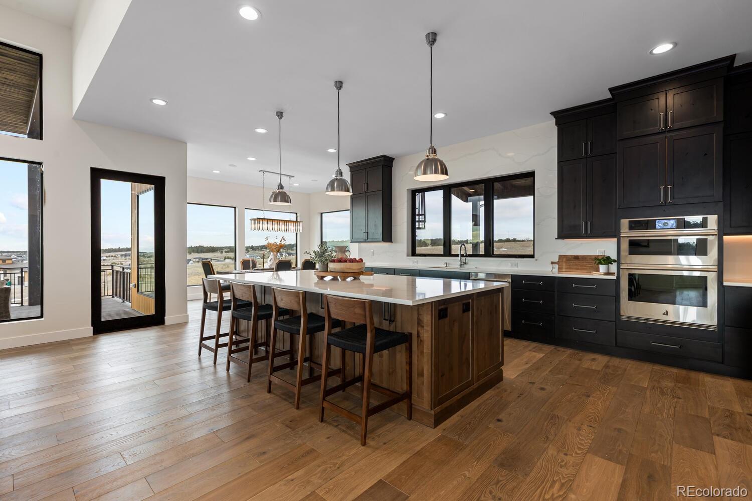 11115 Evening Hunt Road Franktown, CO 80116 - Photo 15 of 46 a large kitchen with a table and chairs