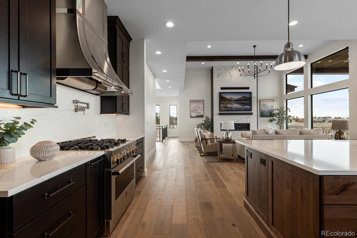 11115 Evening Hunt Road Franktown, CO 80116 - Photo 16 of 46 a kitchen with stove a sink and cabinets