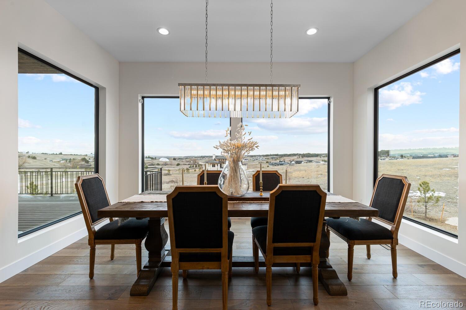 11115 Evening Hunt Road Franktown, CO 80116 - Photo 21 of 46 a view of a dining room with furniture window and wooden floor