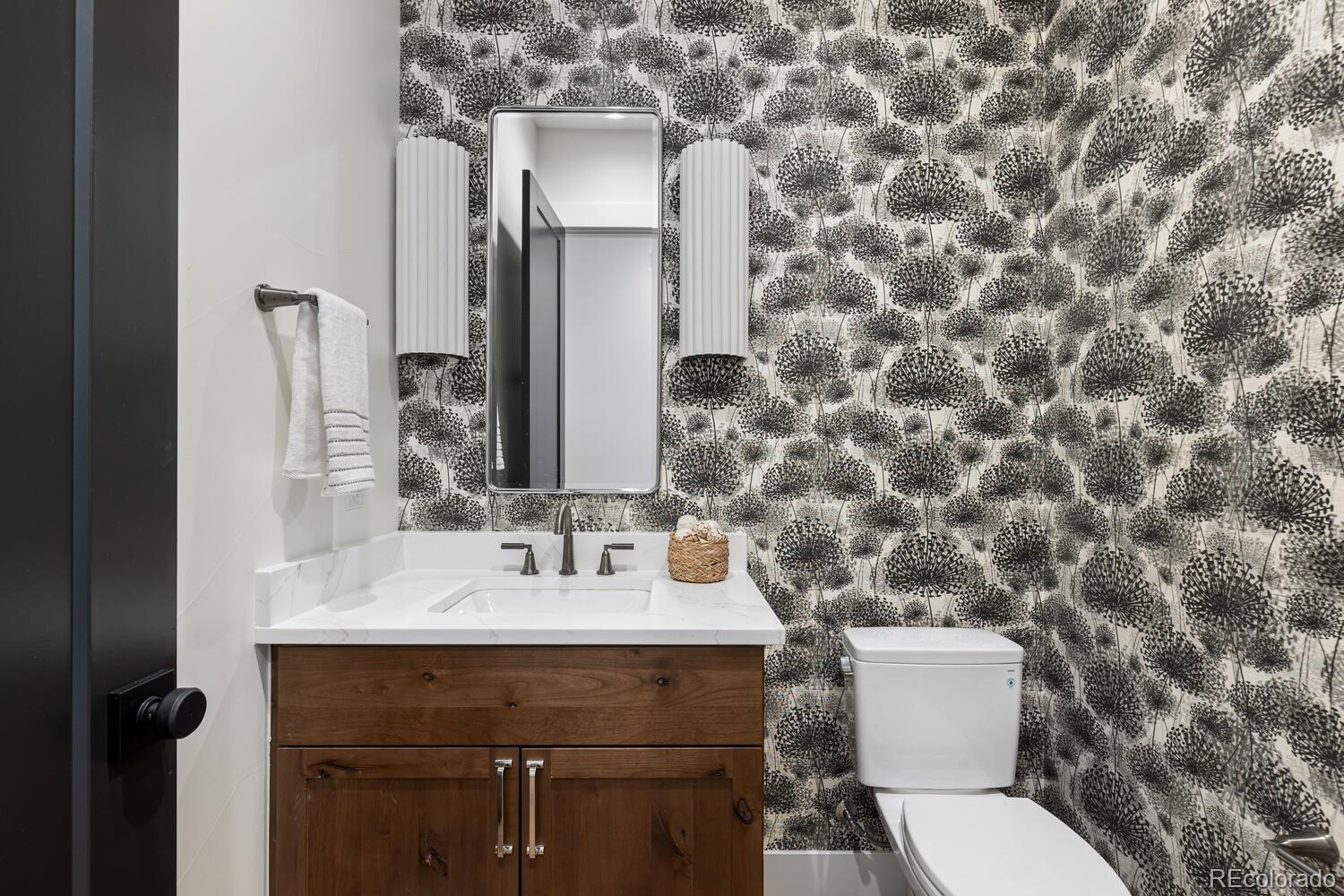 11115 Evening Hunt Road Franktown, CO 80116 - Photo 22 of 46 a bathroom with a sink and a toilet