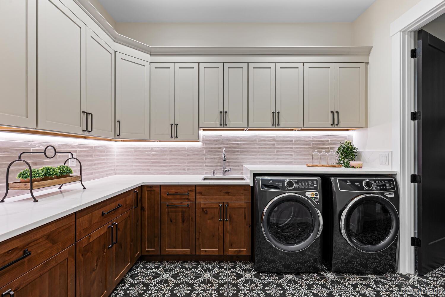 11115 Evening Hunt Road Franktown, CO 80116 - Photo 24 of 46 a kitchen with a cabinets and washer dryer