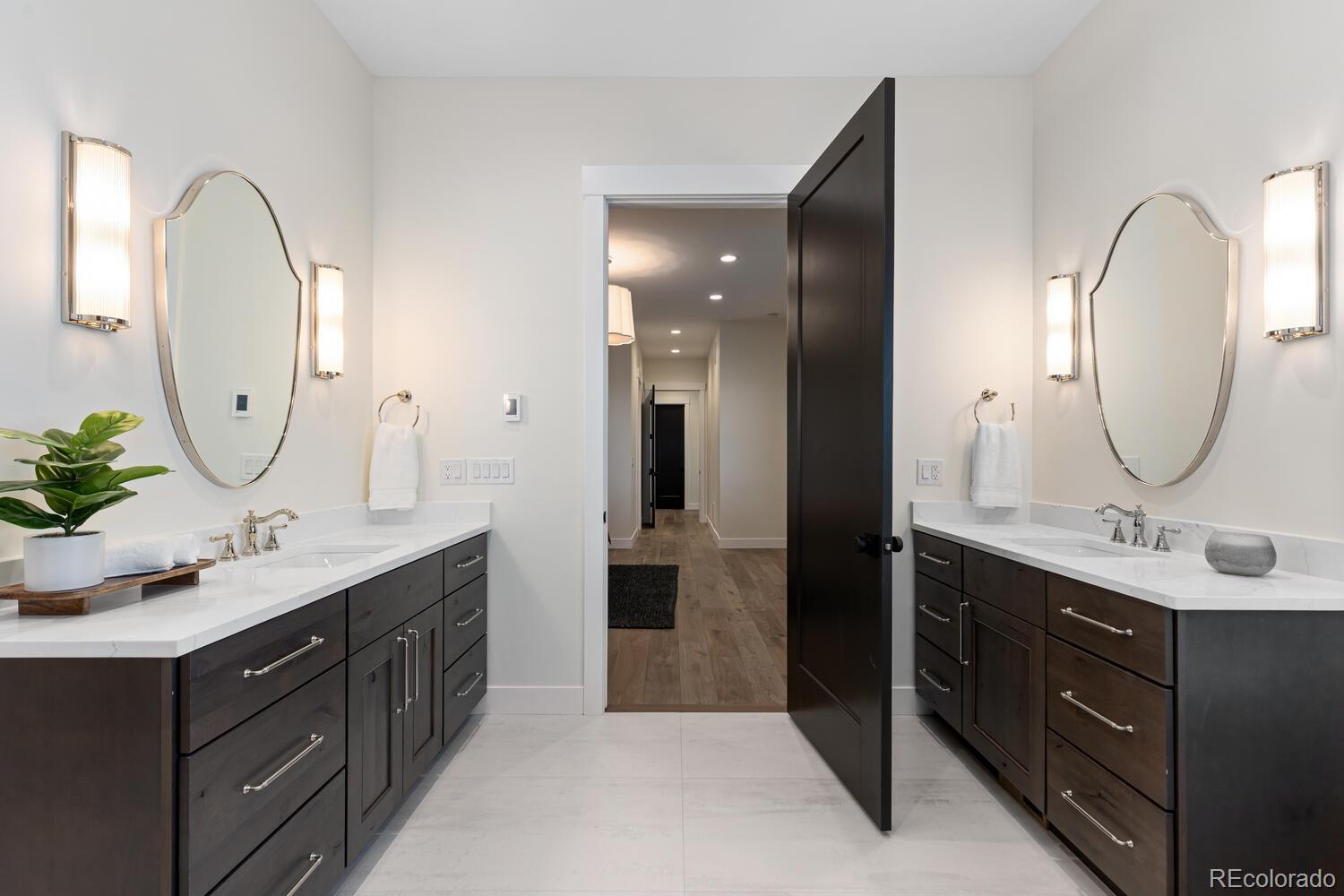11115 Evening Hunt Road Franktown, CO 80116 - Photo 27 of 46 a en suite bathroom with a double vanity sink double and a mirror