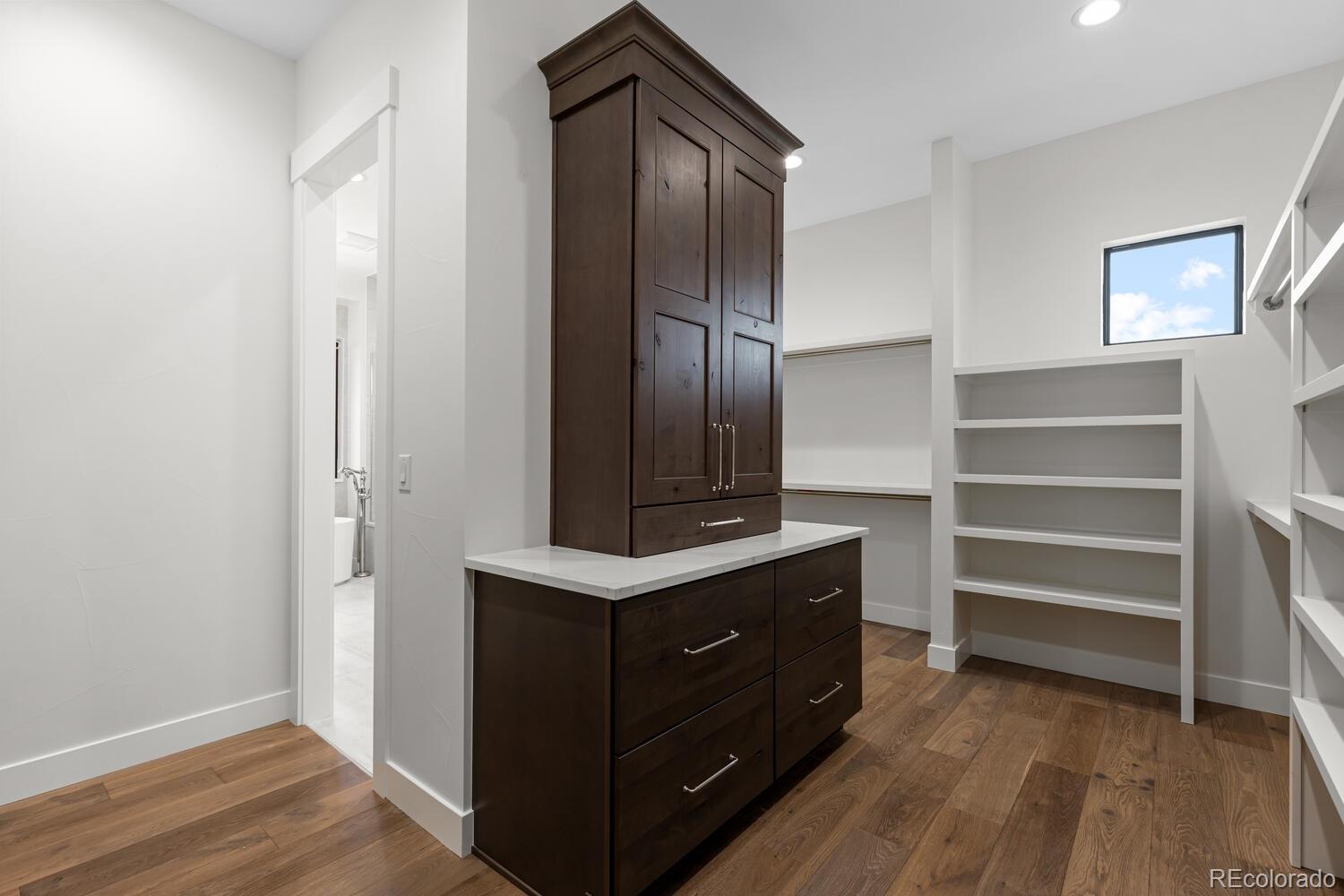 11115 Evening Hunt Road Franktown, CO 80116 - Photo 30 of 46 a room with cabinets and wooden floor