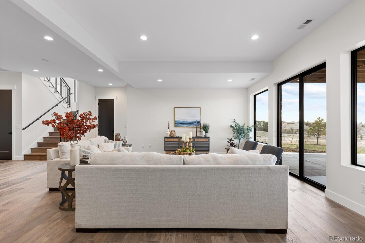 11115 Evening Hunt Road Franktown, CO 80116 - Photo 32 of 46 a living room with furniture fireplace and flat screen tv