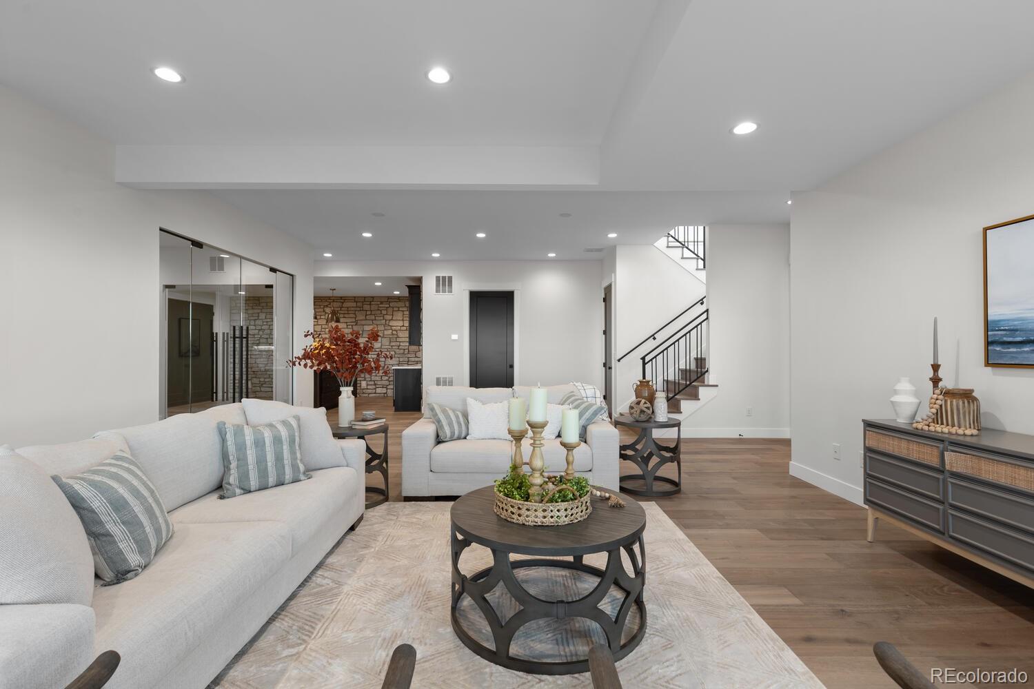 11115 Evening Hunt Road Franktown, CO 80116 - Photo 33 of 46 a living room with furniture kitchen view and a wooden floor