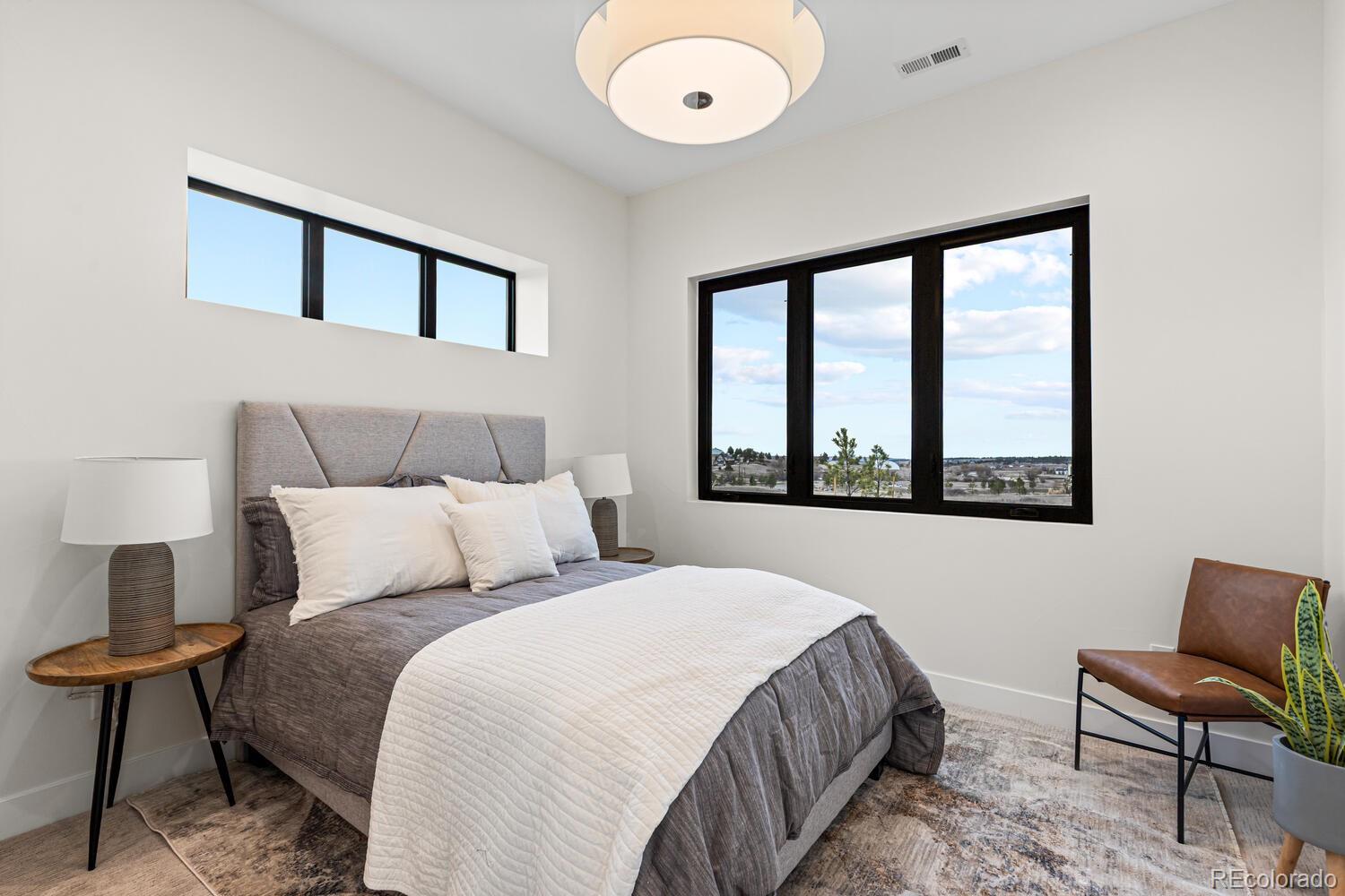 11115 Evening Hunt Road Franktown, CO 80116 - Photo 35 of 46 a bedroom with a bed and a window