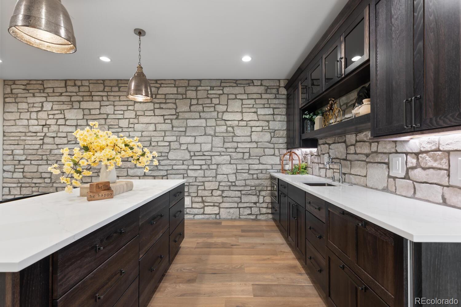 11115 Evening Hunt Road Franktown, CO 80116 - Photo 40 of 46 a kitchen with stainless steel appliances a sink stove and cabinets