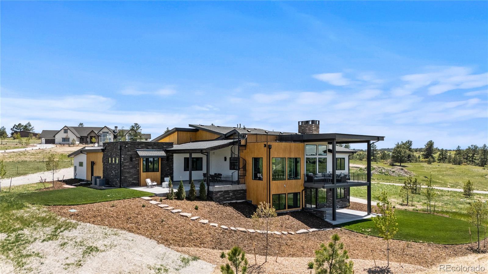 11115 Evening Hunt Road Franktown, CO 80116 - Photo 4 of 46 a front view of a house with a yard