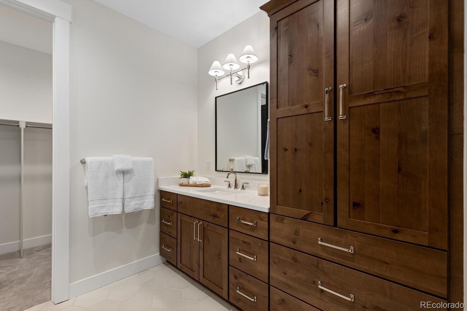 11115 Evening Hunt Road Franktown, CO 80116 - Photo 45 of 46 a bathroom with a double vanity sink and mirror
