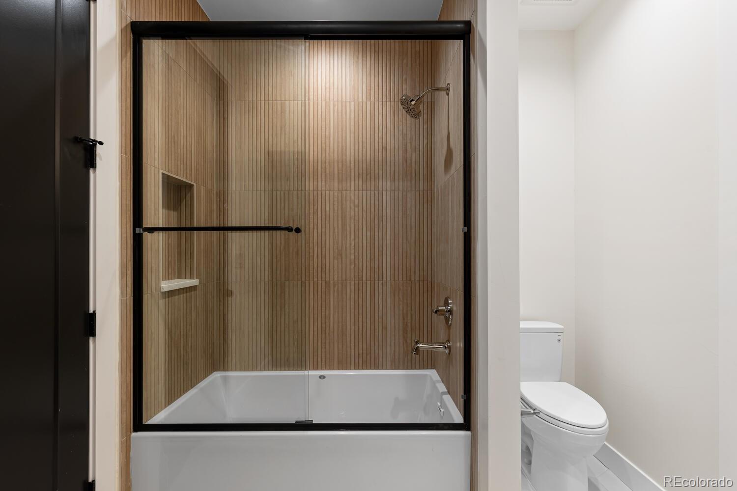 11115 Evening Hunt Road Franktown, CO 80116 - Photo 46 of 46 a view of bathroom with a toilet and a shower