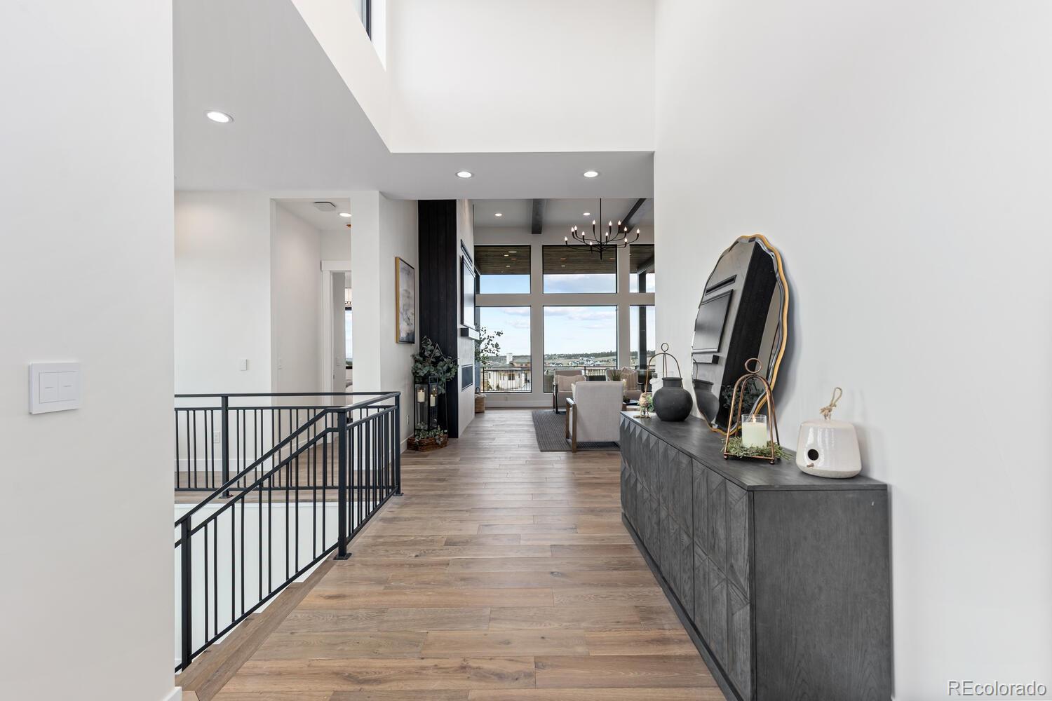 11115 Evening Hunt Road Franktown, CO 80116 - Photo 6 of 46 a view of a hallway with a couch and a window