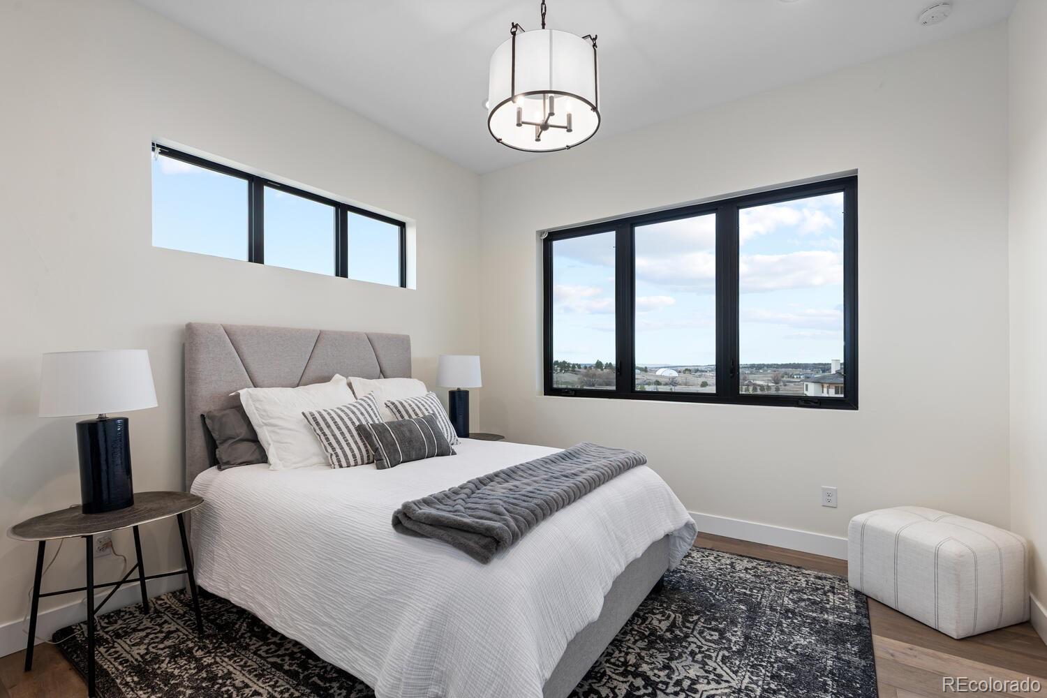 11115 Evening Hunt Road Franktown, CO 80116 - Photo 7 of 46 a bedroom with a large bed and a window