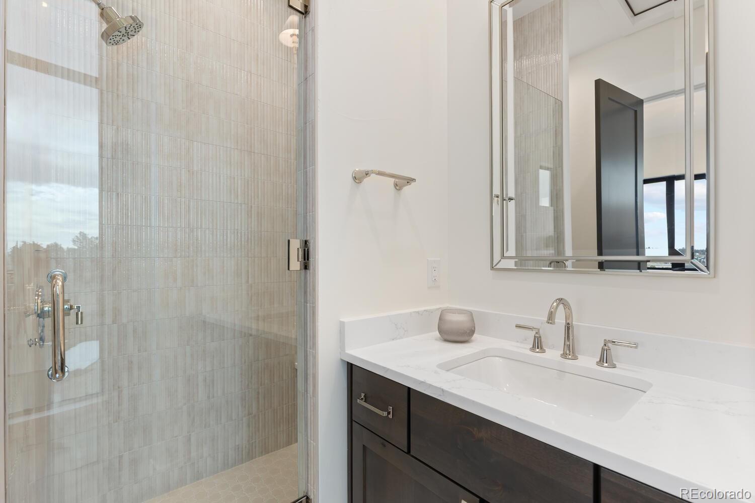 11115 Evening Hunt Road Franktown, CO 80116 - Photo 8 of 46 a bathroom with a sink and a mirror
