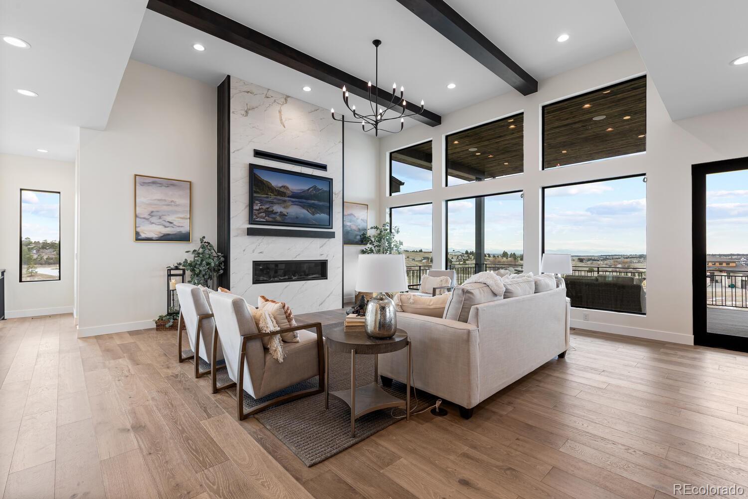 11115 Evening Hunt Road Franktown, CO 80116 - Photo 9 of 46 a living room with furniture window and wooden floor