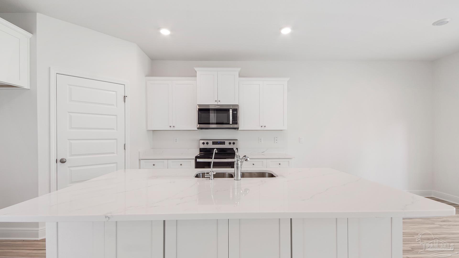3233 Harrier Road Pace, FL 32571 - Photo 41 of 50 a kitchen with stainless steel appliances a microwave and stove