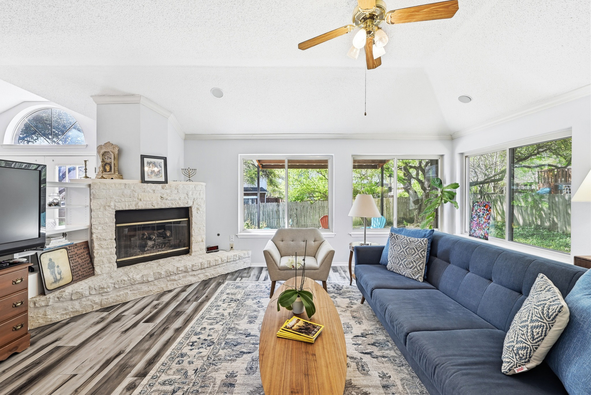 10803 Pinkney Lane Austin, TX 78739 - Photo 11 of 38 Living room with ceiling fan, wood finished floors, and a fireplace